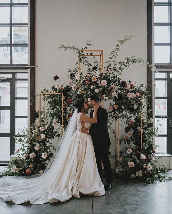 Modern winter indoor ceremony backdrop with reds + pinks - winter, winter wedding, winter wedding ideas,winter ceremony decoration