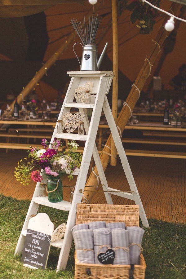 Outdoor tipi farm wedding decoration with ladder and watering can