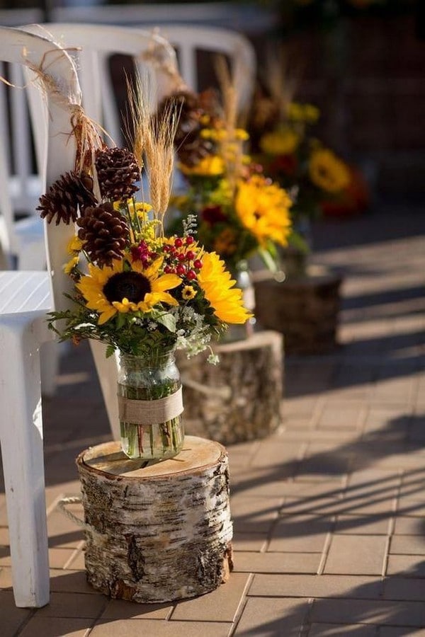 Sunflower bouquets in glasses and on birch trunks Rustic country sunflowers wedding centerpiece ideas
