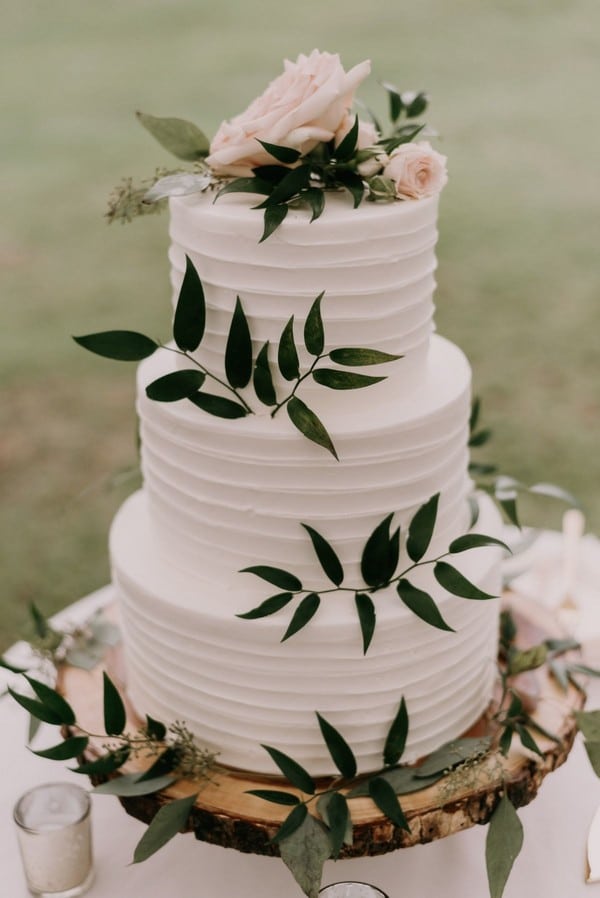 White wedding cake with greenery
