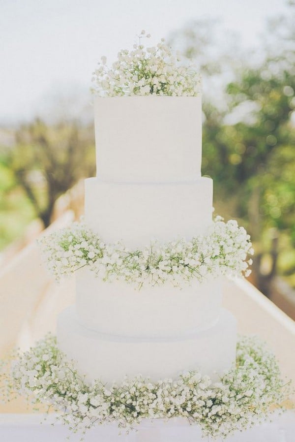 all white wedding cake with babys breath