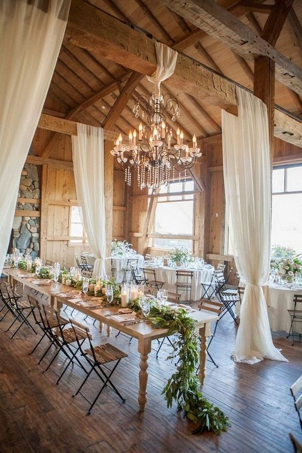 barn wedding reception decor ideas with draping fabric and greenery table runner