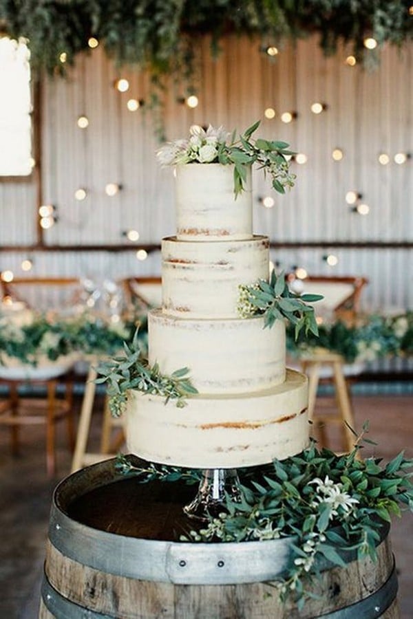 green and white wedding cake on a wine barrel