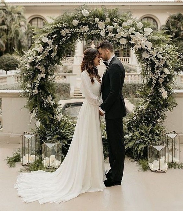 greenery winter circle wedding backdrop with lanterns