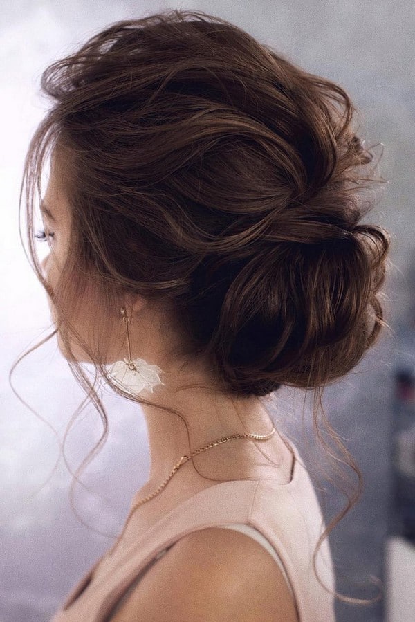 messy elegant low bun wedding hairstyle