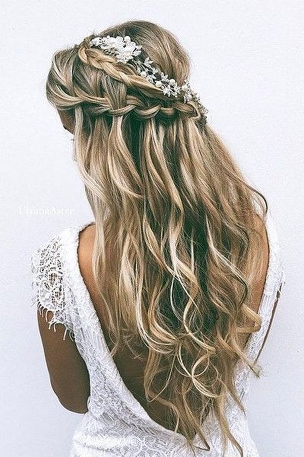 romantic half up half down wedding hairstyle with braids and babys breath