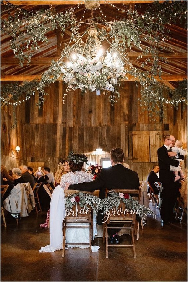 rustic barn wedding reception with greenery