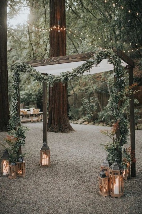 rustic greenery and lantern wedding arch