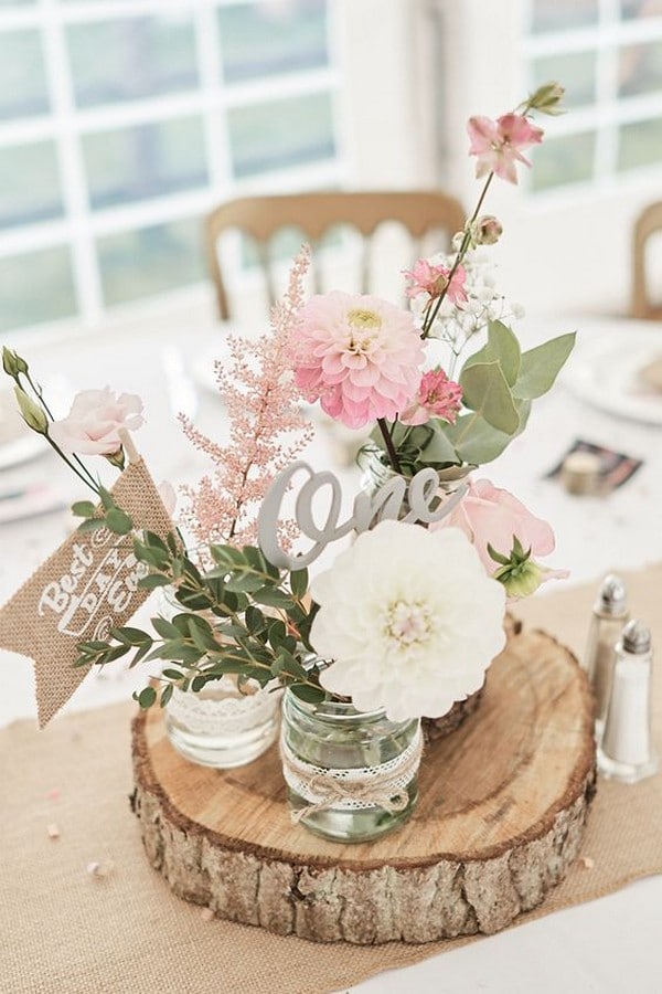 rustic pink wedding centerpiece with tree stump