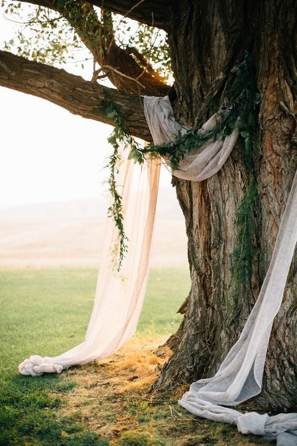 simple wedding backdrop ideas with drapery and greenery