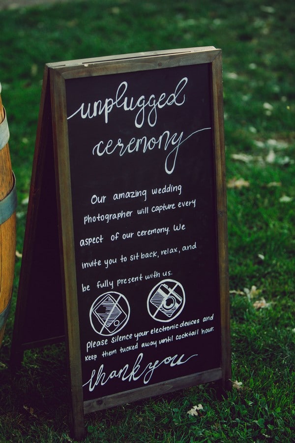 unplugged wedding ceremony sign on a chalk board