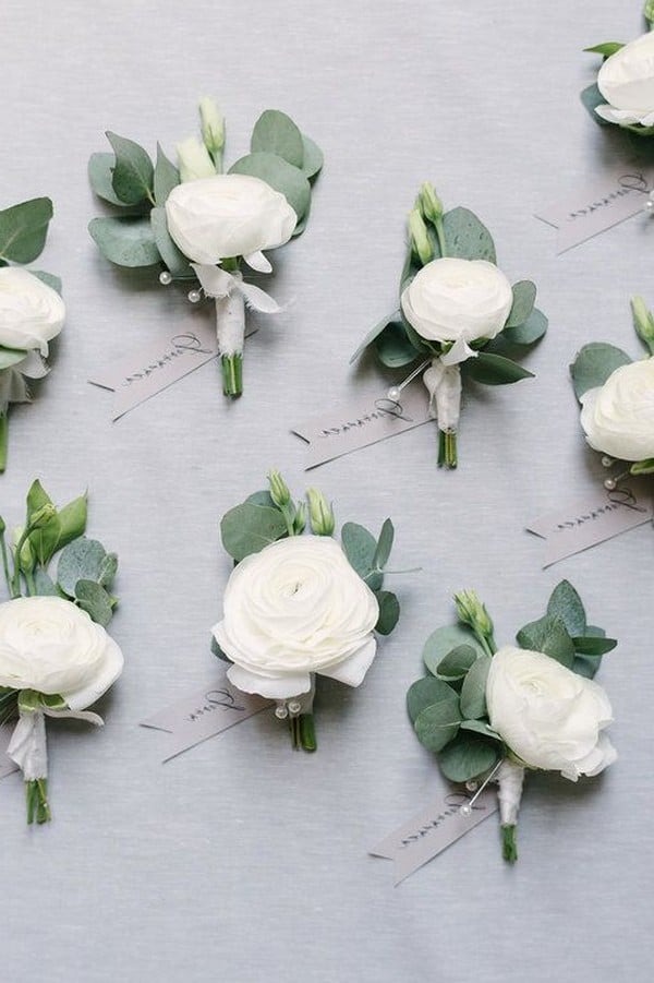 white roses and eucalyptus arrangements for groom