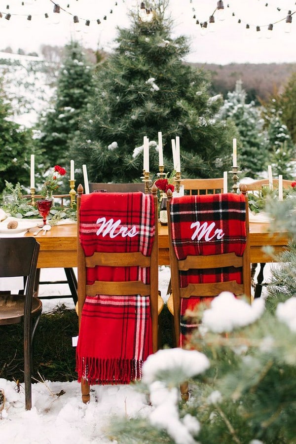 winter wedding decorations a wedding table on the street decorated with white candles of golden candlesticks and chairmasters with a red checkered scarf utah event wedding planner via inst