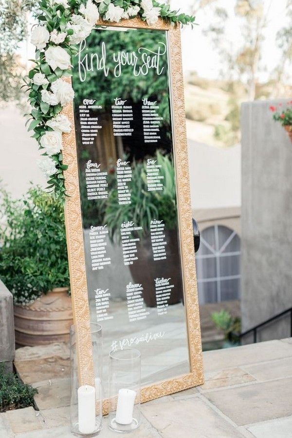 chic vintage mirror wedding seating chart with greenery