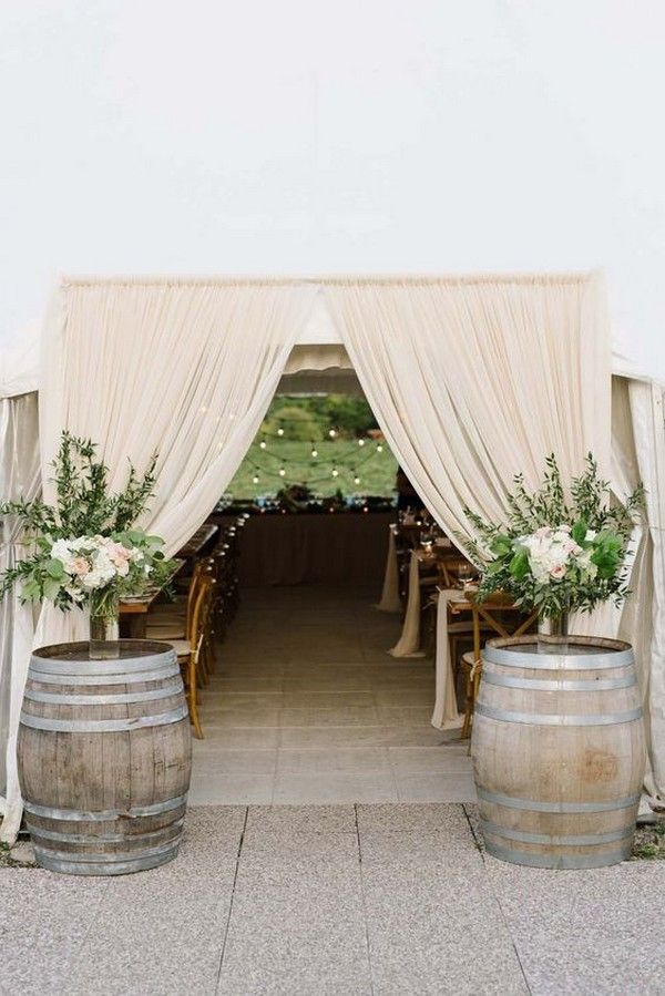 rustic country wine barrel wedding entrance decorations for a tent wedding