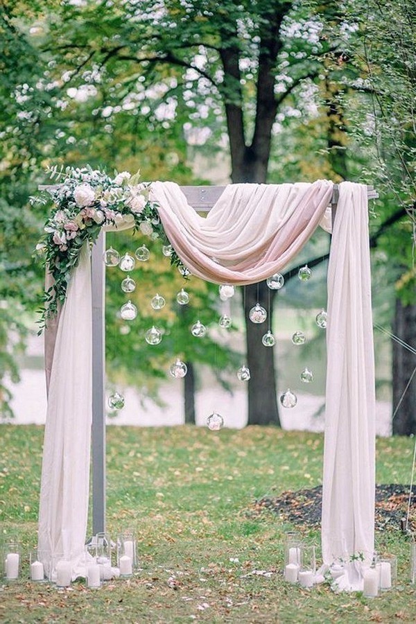 blush pink draped fabric wedding arch