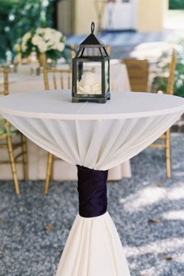 chic wedding cocktail table with black ties