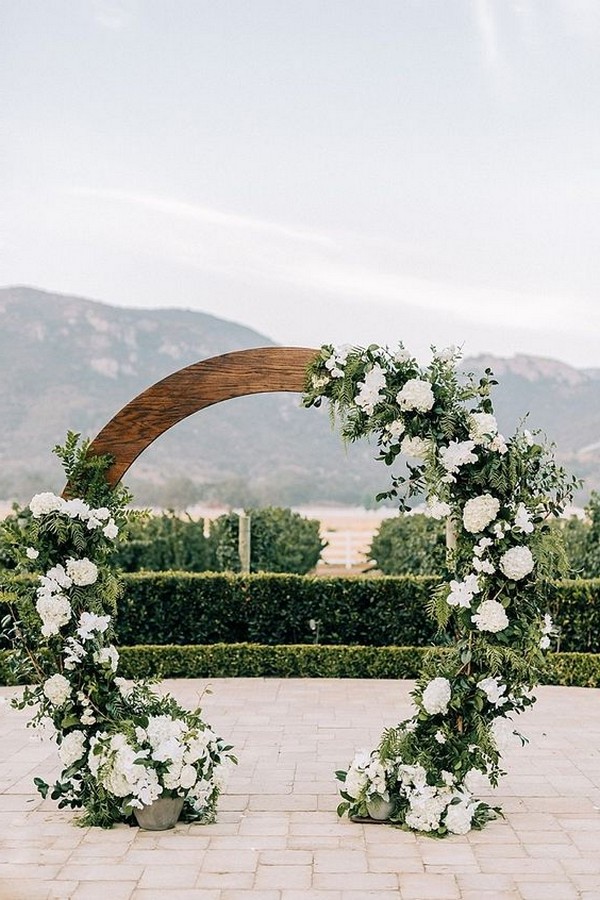 chic wooden circular wedding arch with white and green floral