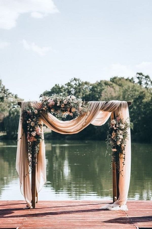 dusty rose draped fabric wedding arch
