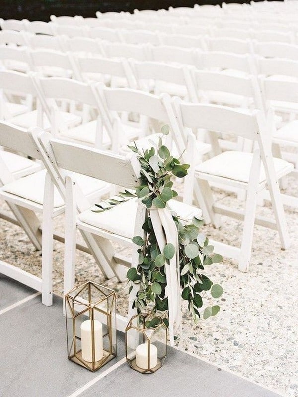 elegant outdoor wedding aisle ideas with greenery and lanterns