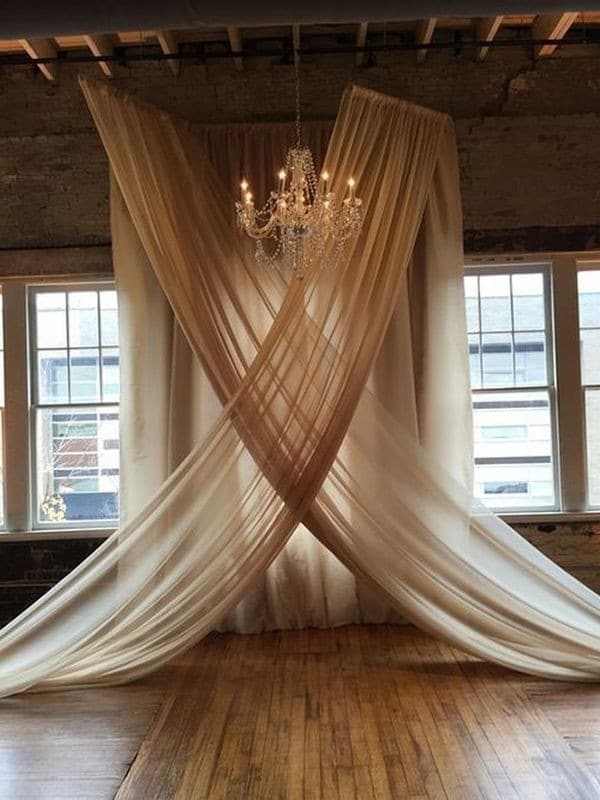 elegant wedding backdrop ideas with chandelier and chiffon drapery