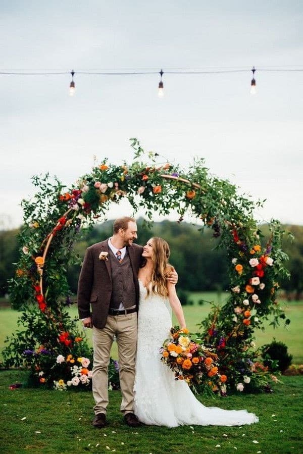 fall green and moody flowers circle wedding backdrop