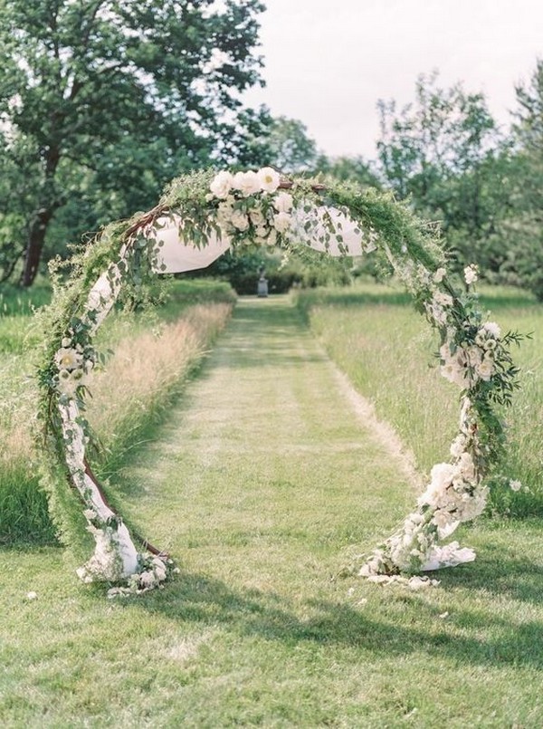 greenery and white circular floral wedding arch