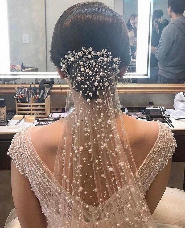 low bun updo wedding hairstyle with pearls veil