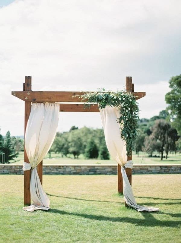 outdoor draped wedding ceremony arch