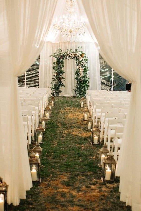 romantic wedding ceremony decoration ideas with lantern aisle and draped fabric