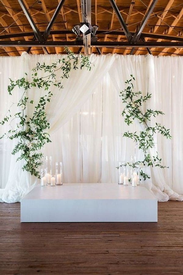 simple elegant wedding backdrop ideas with greenery and white drapery