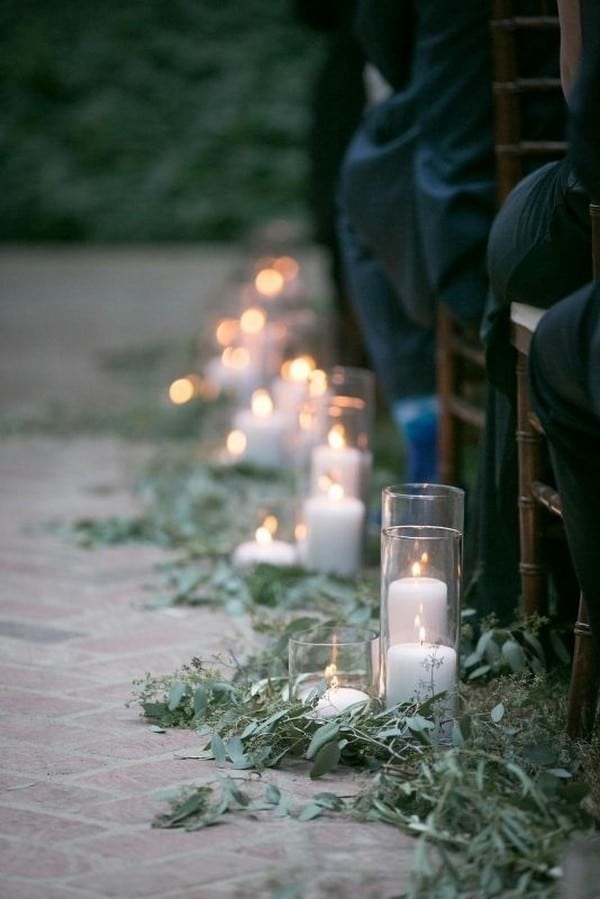 wedding ceremony aisle with branches and candles