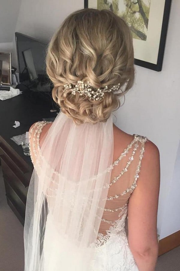 wedding hairstyles with veil on blonde bridal hair with low curly updo jojo_hicks_mua via instagram