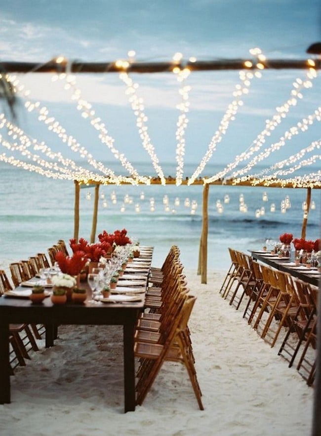beach side wedding reception with string lights