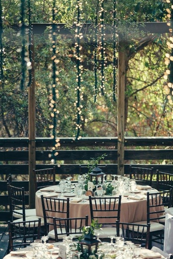 round table wedding reception ideas with lanterns in the forest